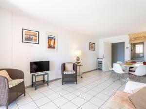Una sala de estar con un sofá, un televisor y una mesa. en Apartment Les Mandariniers by Interhome, en Le Lavandou 20 fotos más