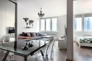 a living room with a glass table and a couch at Comfy Flat in the City Center in Warsaw