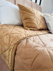 a bed with two pillows on top of it at Luxury Self-Catering Apartment in Johannesburg