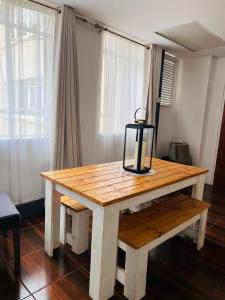 a wooden table with a lantern on top of it at Luxury Self-Catering Apartment in Johannesburg