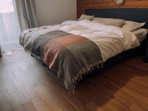 - un lit avec couverture dans une chambre dans l'établissement Das Luis, à Altenmarkt im Pongau