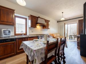 a kitchen with a table with a table cloth on it at Apartment Maison Pro de Solari-2 by Interhome in Fenis