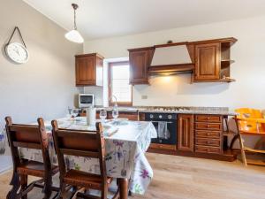a kitchen with a table with chairs and a stove at Apartment Maison Pro de Solari-2 by Interhome in Fenis