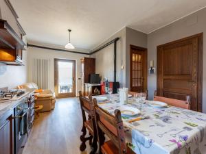 a kitchen with a table with a table cloth on it at Apartment Maison Pro de Solari-2 by Interhome in Fenis