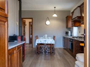 a kitchen with a table with a table cloth on it at Apartment Maison Pro de Solari-2 by Interhome in Fenis +26 photos