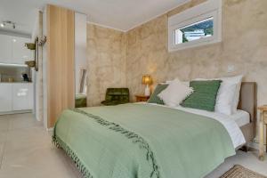a bedroom with a large bed with a green blanket at Casa La Naranja Boutique Hotel B&B LaCasita in Pedreguer +5 photos