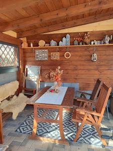 a wooden cabin with a table and two chairs at Apartmany Adavy in Liptovský Mikuláš