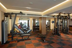 a gym with several tread machines in a room at ARISTA BY AMBITION in Guwahati