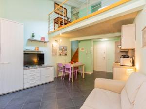 a kitchen and a living room with a table at Apartment Blue Diamond by Interhome in Bellano