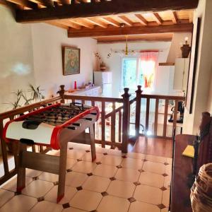 a living room with a bed and a kitchen at Maison Cosy et Conviviale, Le B7 in Besset