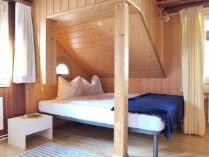 a bedroom with a bed in a wooden room at Apartment Wellhorn by Interhome in Meiringen