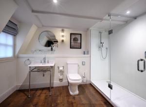 a bathroom with a toilet and a sink and a shower at Abbey Hotel Bath, a Tribute Portfolio Hotel in Bath