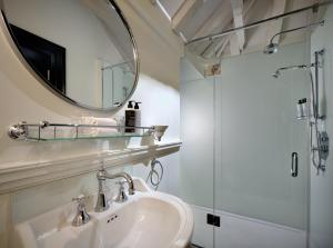 a bathroom with a sink and a mirror at Abbey Hotel Bath, a Tribute Portfolio Hotel in Bath