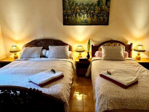 a bedroom with two beds with towels on them at Superb family friendly villa with pool and only 500 metres from beach in Montongbuwoh