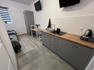 a kitchen with a sink and a counter top at Hostel Adabet in Kępno