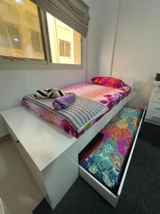 a room with two beds and a window at The Regal Residency Studio, 1 Minute Walking Distance from Gold Souk in Dubai