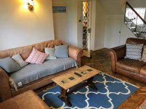 a living room with a couch and a coffee table at Lavender Row Stedham in Midhurst