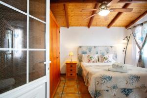 a bedroom with a bed and a glass door at Minipiso Tejina de Isora in Guía de Isora