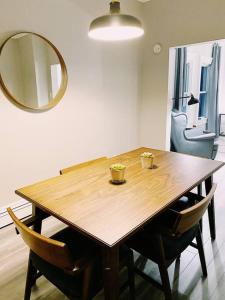 a dining room table with chairs and a mirror at The LOCAL BREW Perfect For FOODIES + BEER LOVERS in Fredericton