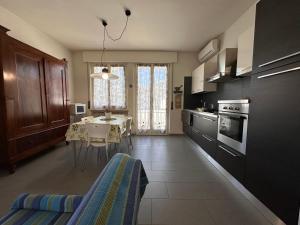 a kitchen with a table and a dining room at APPARTAMENTO LIDA in Lazise