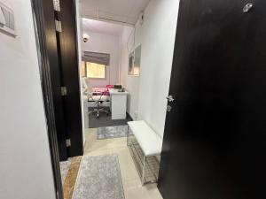 a door to a room with a table and a chair at The Regal Residency Studio, 1 Minute Walking Distance from Gold Souk in Dubai