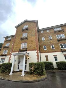 a large brick building with windows and balconies on it at Spacious Quiet Stylish entire flat in London
