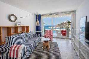 a living room with a couch and a view of the ocean at Marina Suites Gran Canaria in Puerto Rico de Gran Canaria