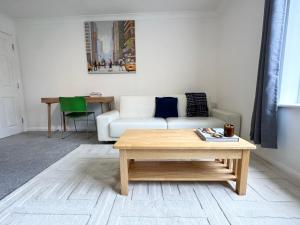 a living room with a couch and a coffee table at Spacious Quiet Stylish entire flat in London