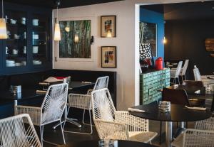 a restaurant with tables and chairs and a counter at Marina Bayview Gran Canaria - Adults Only in Puerto Rico de Gran Canaria