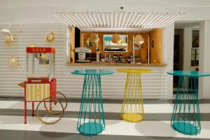 a bar with two tables and a bike in a room at Gold Playa del Ingles - Adults Only in Playa del Ingles