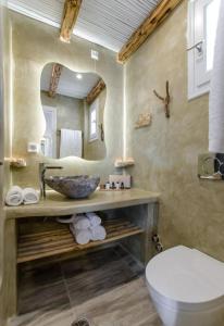 a bathroom with a sink and a toilet at Glaronissi Beach in Plaka