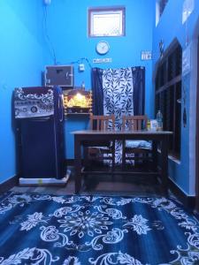a blue room with a table and chairs on a blue floor at Hari Suman Paying Guest house in Ayodhya