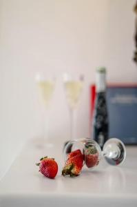 two strawberries in measuring cups on a kitchen counter at Glaronissi Beach in Plaka