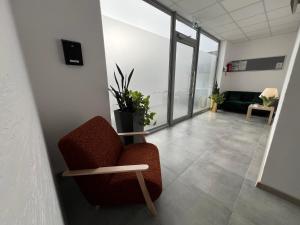 a living room with a chair and a couch at Hostel Adabet in Kępno