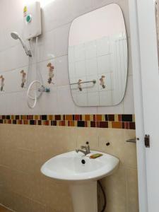 a bathroom with a sink and a mirror at Ruen Nam Khoa Resort -Klongthom Krabi in Khlong Thom