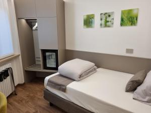 a small bedroom with a bed and a fireplace at Hotel Pace in Brenzone sul Garda