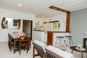 a dining room and kitchen with a table and chairs at Neza Haven Kigali in Kigali