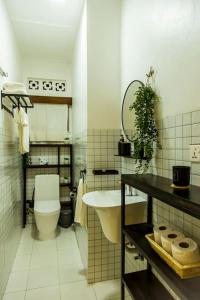 a bathroom with a white toilet and a sink at Neza Haven Kigali in Kigali