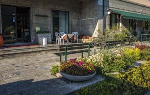 a flower garden in front of a building at Albergo Sporting in Endine Gaiano