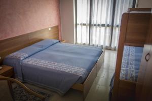 Un pat sau paturi într-o cameră la Albergo Sporting