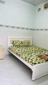 a white bed in a white room with at Phúc Nguyễn House in Lagi