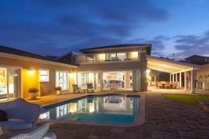 a house with a swimming pool in the backyard at Sunrise on Stiebel Rocks in Umzumbe