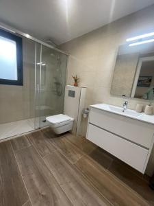 a bathroom with a toilet and a sink and a shower at Rancho Luxury apartments in Platja d'Aro