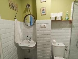 a white bathroom with a toilet and a sink at Estudio LA paradise in Torremolinos