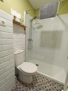 a white bathroom with a toilet and a shower at Estudio LA paradise in Torremolinos