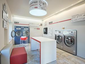 a laundry room with two washing machines and a counter at Alpe di Susi in Castelrotto