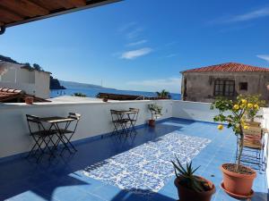 a view from the roof of a house with chairs and tables at B&B La Filanda in Scilla