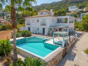 an aerial view of a house with a swimming pool at Casa La Naranja Boutique Hotel B&B LaCasita in Pedreguer
