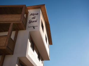 a sign on the side of a building at Alpe di Susi in Castelrotto