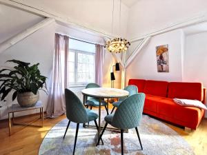 a living room with a red couch and chairs at BohnApartments Steigerwald - Natur in der Stadt - Vollausstattung - WLAN - Parkplätze in Erfurt